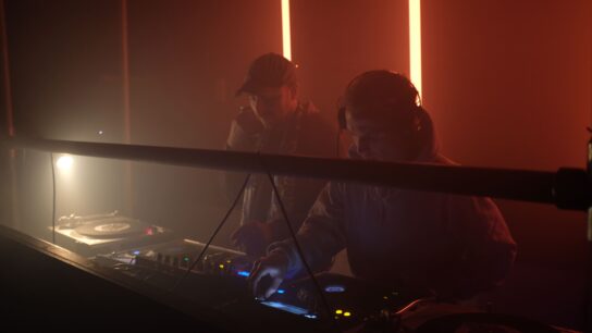 Photo of DJs in a nightclub